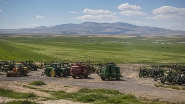 Farm equipment yard and hay fields on the high plateau outside Enterprise, Utah — local commercial insurance risk factors for Enterprise, Utah 84725 businesses