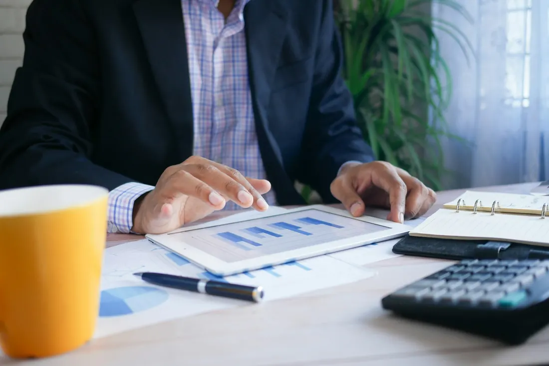 Small business owner reviewing financial charts on a tablet — Utah business insurance cost