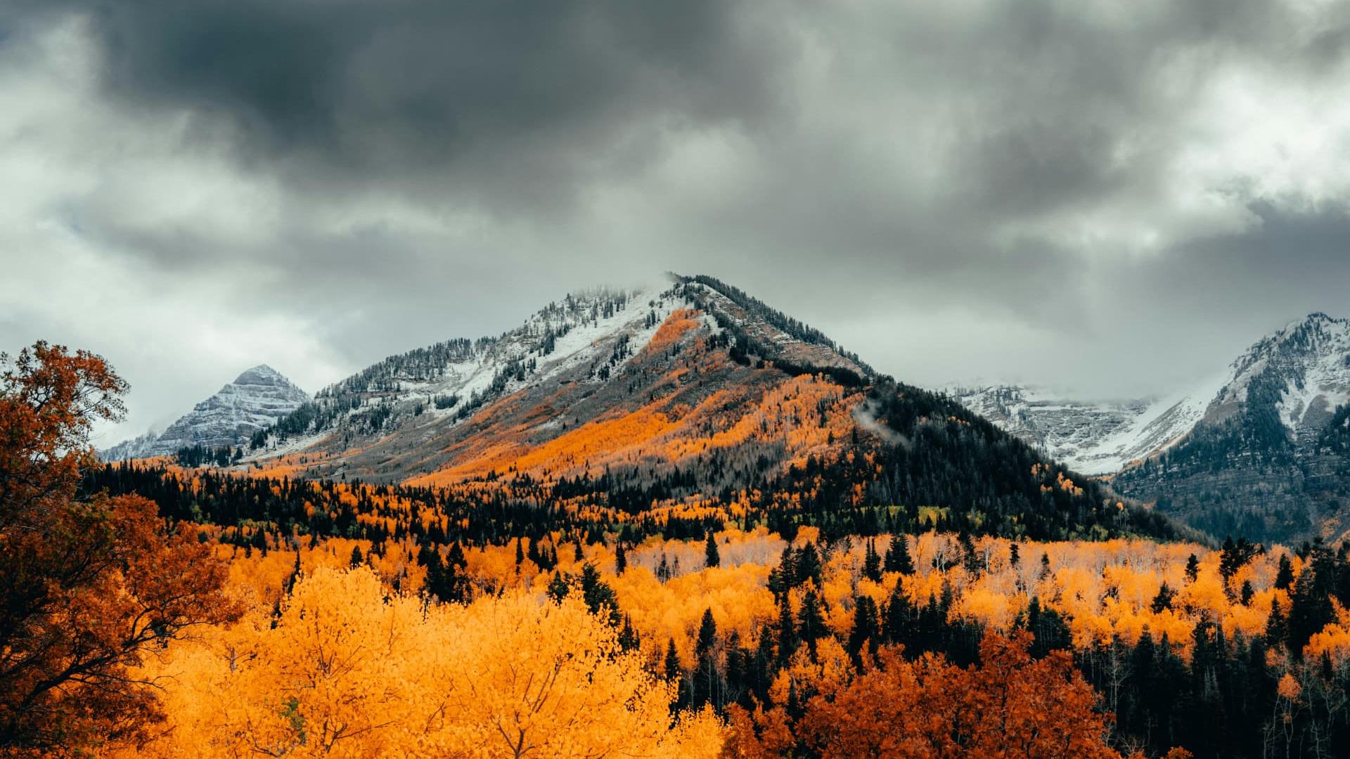 Snow-dusted peaks above golden autumn aspens under storm clouds near Cedar City, Utah — ACA / Obamacare health insurance enrollment for 84720 and 84721 households, Iron County contractors, and self-employed families