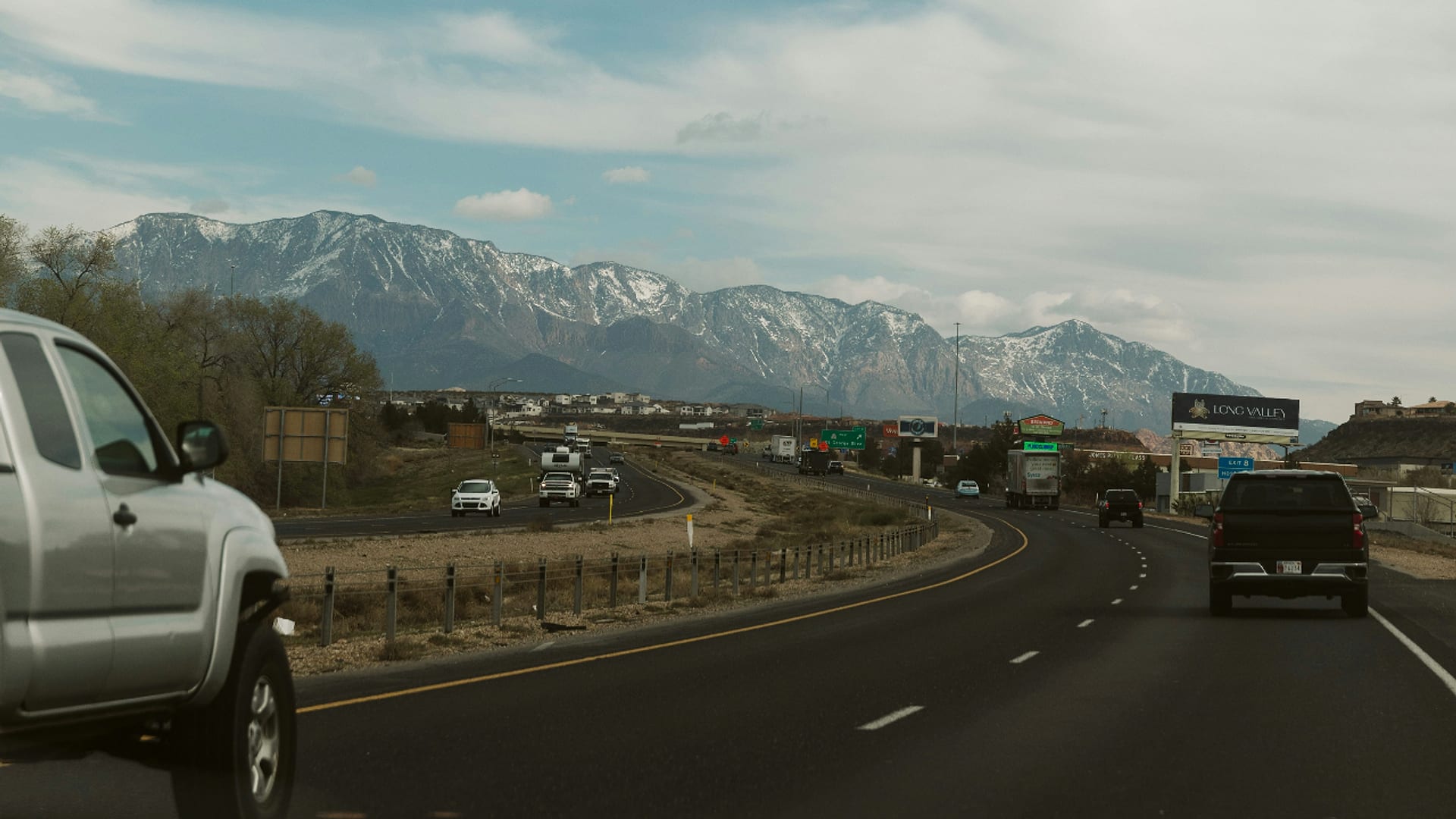 Interstate 15 approaching St. George, Utah with snow-capped Pine Valley Mountains in the distance — auto insurance for St. George drivers