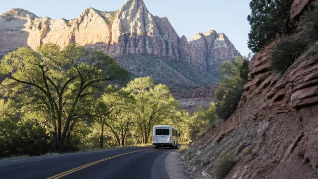 Tour shuttle on the canyon road beneath Zion's sandstone cliffs near Springdale, Utah — local commercial insurance risk factors for Springdale, Utah 84767 businesses