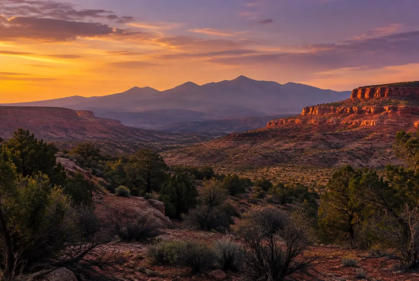 Desert valley at dusk in Southern Utah with mountains on the horizon