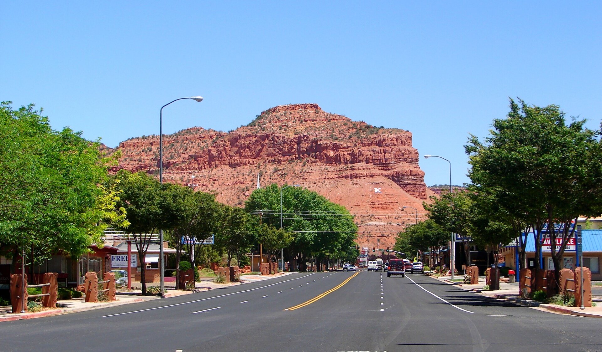 Center Street in downtown Kanab, Utah looking north toward the red sandstone cliffs and the white K on the hill — auto insurance for Kanab and Kane County drivers in 84741