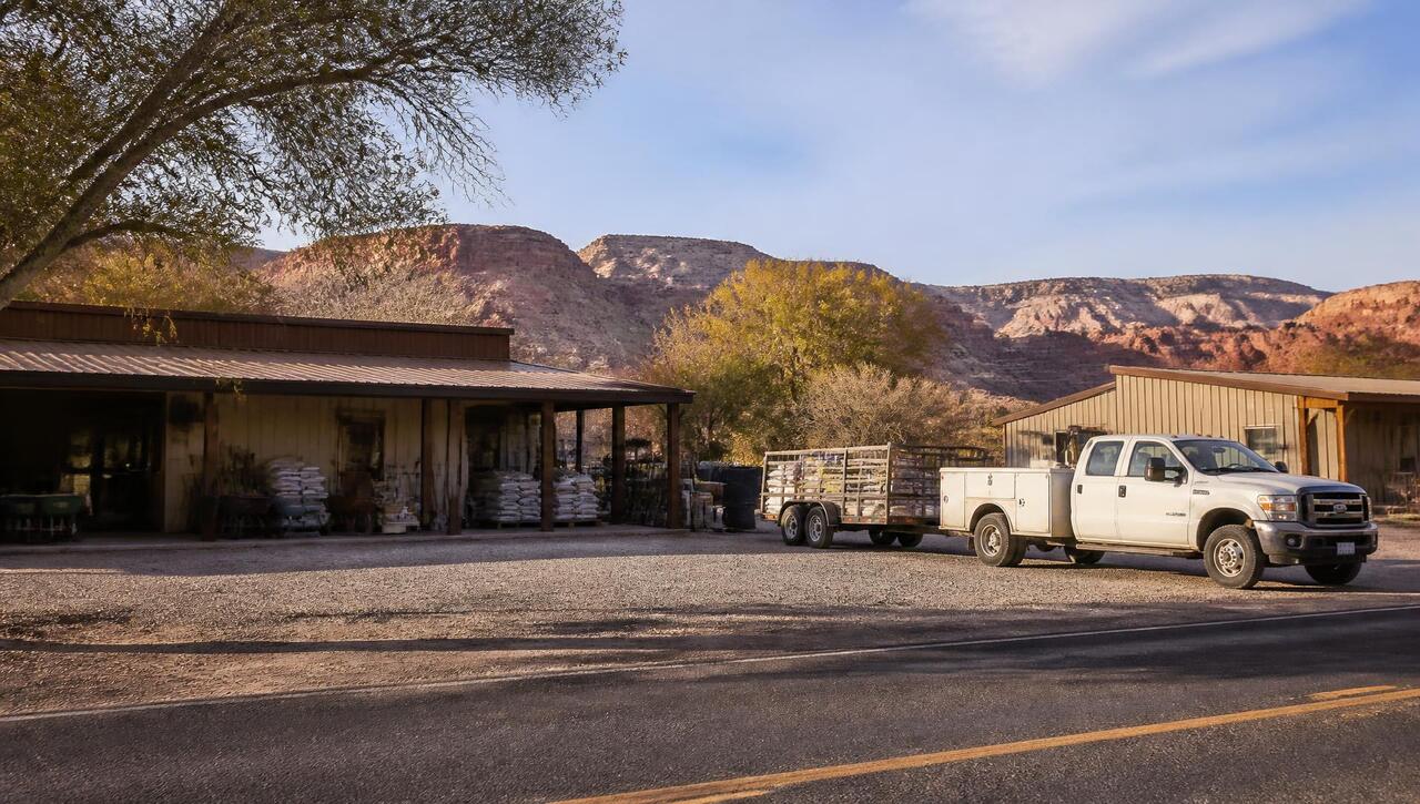Highway-frontage hardware store and gravel lot in La Verkin, Utah with canyon walls behind (ZIP 84745) — business insurance, BOP, general liability, commercial property and workers' comp for La Verkin, Utah employers