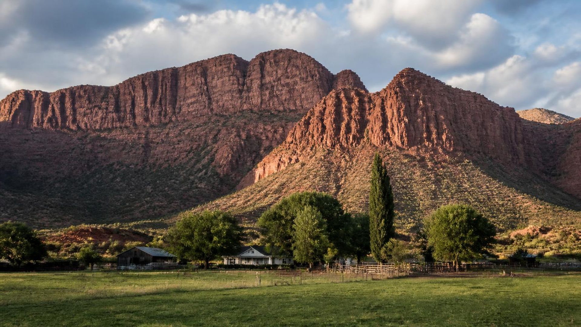 Farm homes and barns below the towering red Kanarra Mountain cliffs in Kanarraville, Utah (ZIP 84742) — ACA / Obamacare Marketplace health insurance, subsidies and off-Marketplace plans for Kanarraville, Utah households