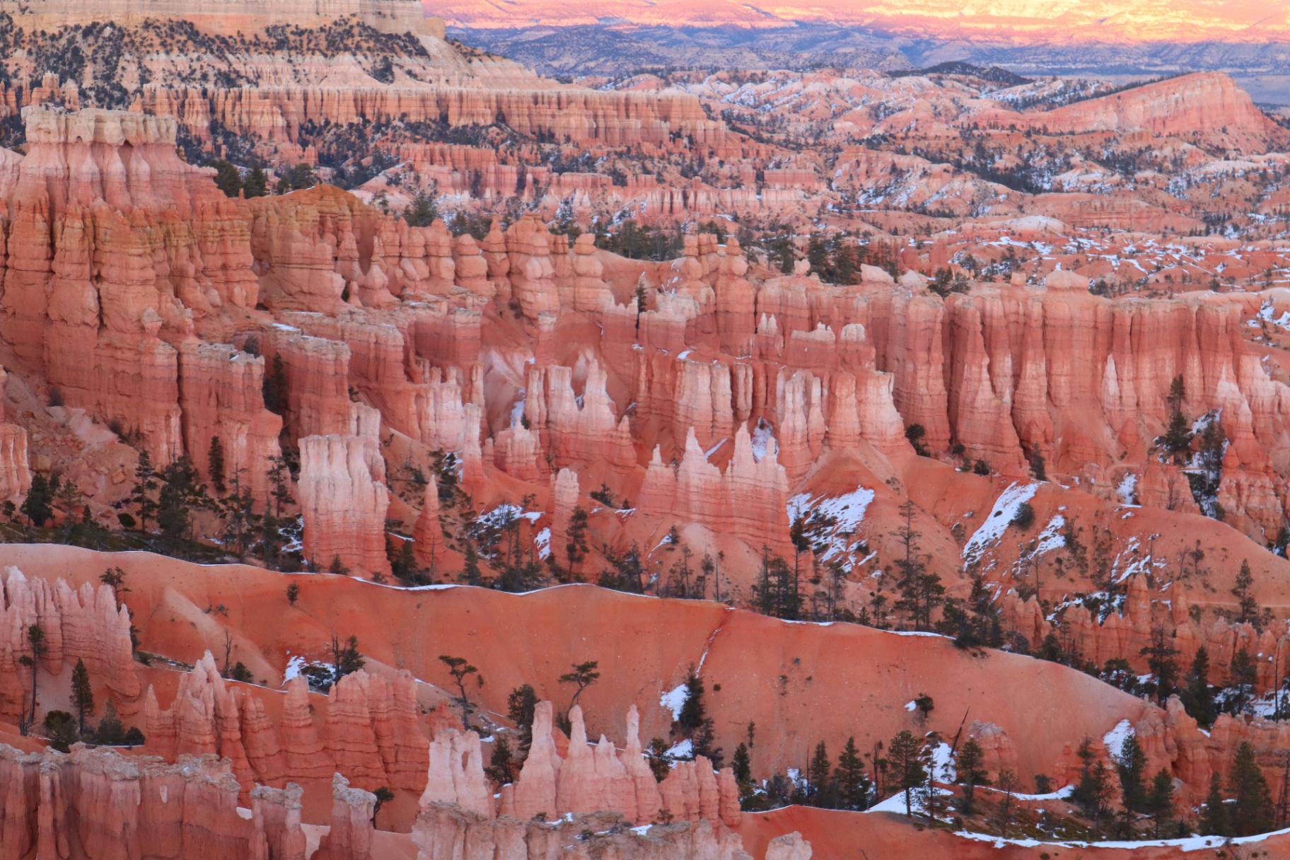 Sunset over red-rock hoodoos and pinnacles above La Verkin, Utah — the wildland-urban interface and Smith Mesa exposure carriers rate into every 84745 homeowners insurance quote