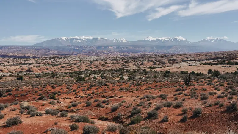 Red desert flats below distant snow-capped peaks near La Verkin, Utah — 84745 ACA health insurance, Utah Medicaid eligibility, and cost-sharing Silver plans