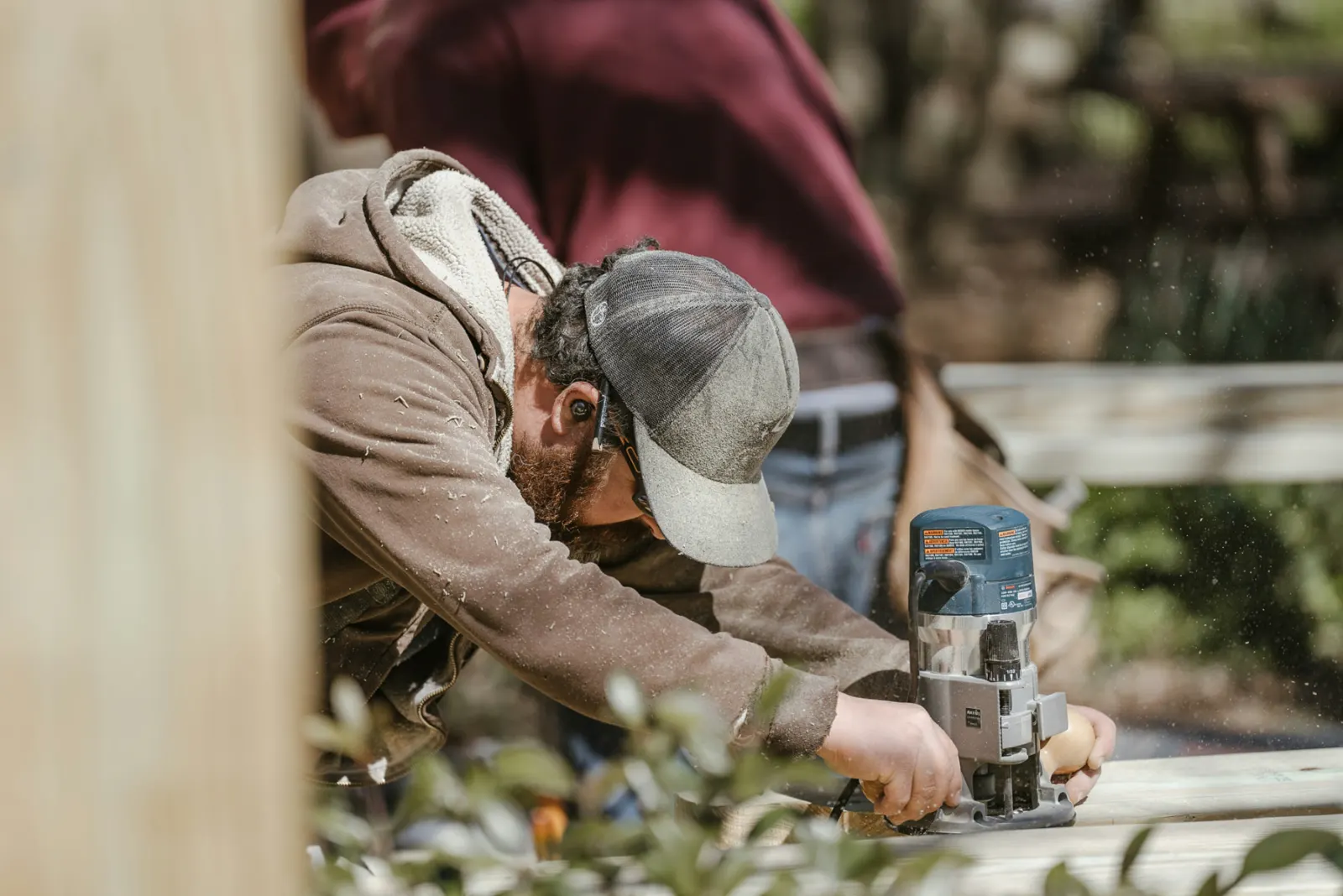 Finish carpenter routing a wood rail on a St. George, Utah project — tools and installation coverage for 84770 trades