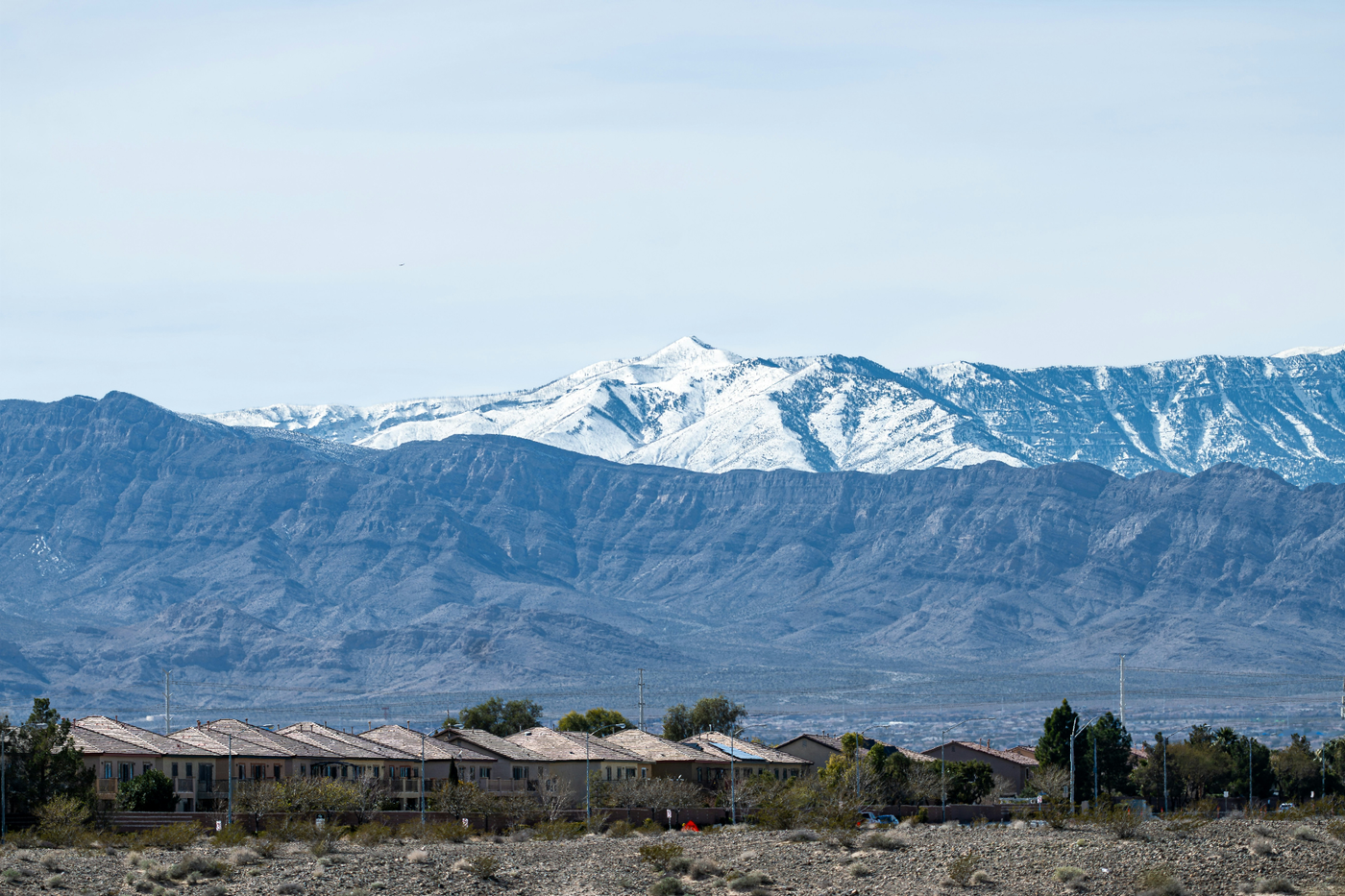 Snow-capped Virgin Mountains rising above the Sun City Mesquite rooftops in Mesquite, Nevada — winter elevation and I-15 routing that shape Clark County 89027 auto rates