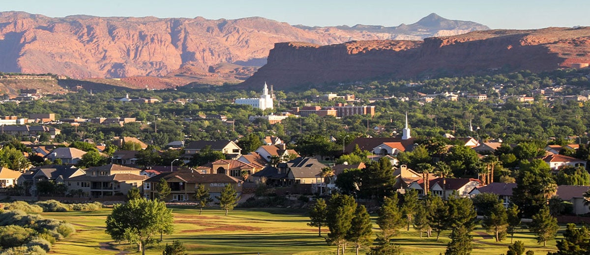 Saint George, Utah valley view with the LDS temple, neighborhoods, and red sandstone cliffs — homeowners insurance for 84770, 84771, 84790, 84791