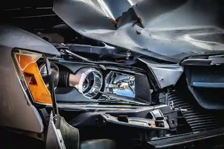 Close-up of front-end collision damage to a business vehicle