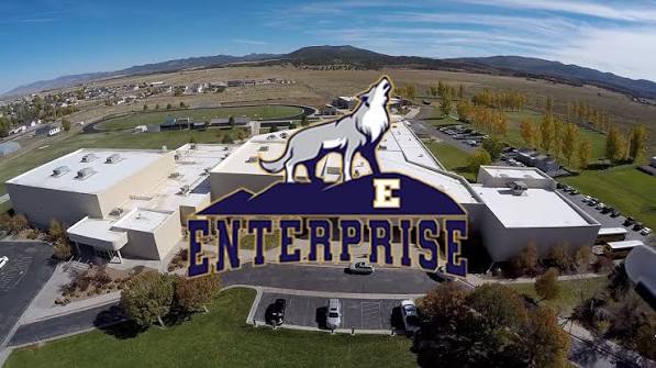Enterprise High School aerial view with the Wolves logo and white E on the hillside — Enterprise, UT 84725.