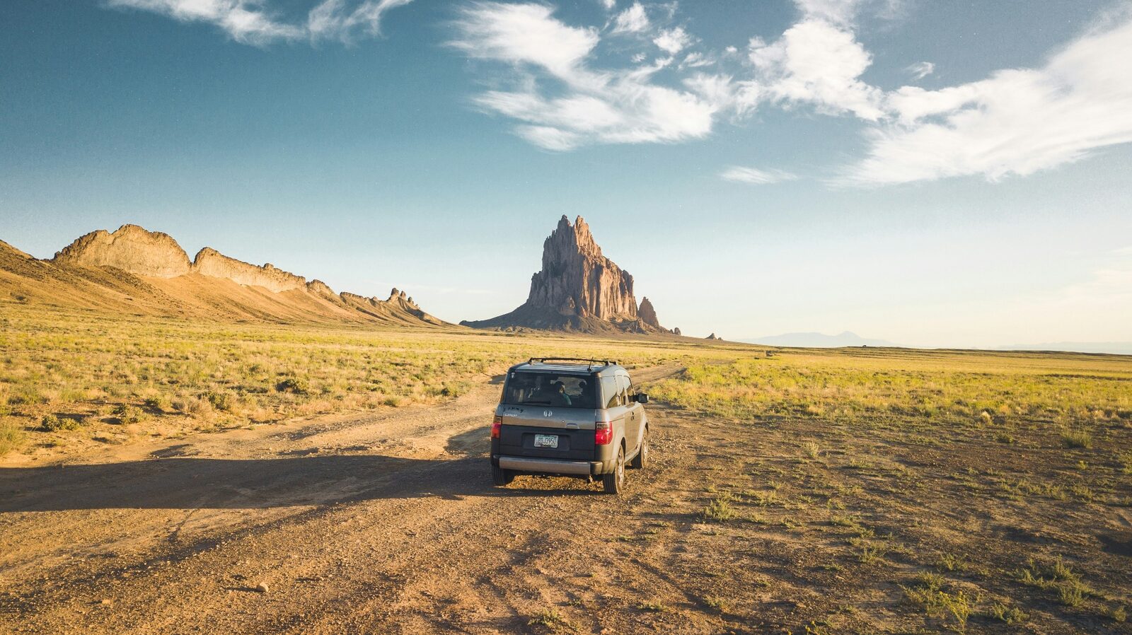Honda Element on a desert backroad outside Hurricane, Utah with Zion-area red-rock cliffs and mesas on the horizon — Hurricane auto insurance brokers