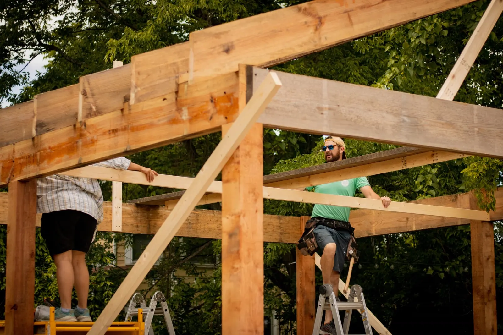 Two framers setting timber beams on a Southern Utah structure — workers' comp and builders risk for St. George framing crews