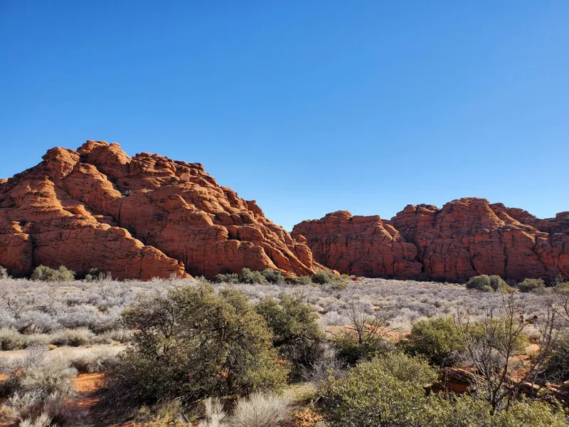 Sunlit red sandstone buttes above high desert brush near Kanab, Utah, where seasonal tourism income shapes 84741 Marketplace subsidy estimates