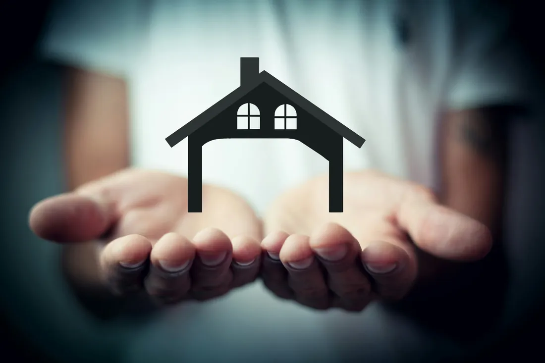 Hands holding a house icon representing renters insurance protection