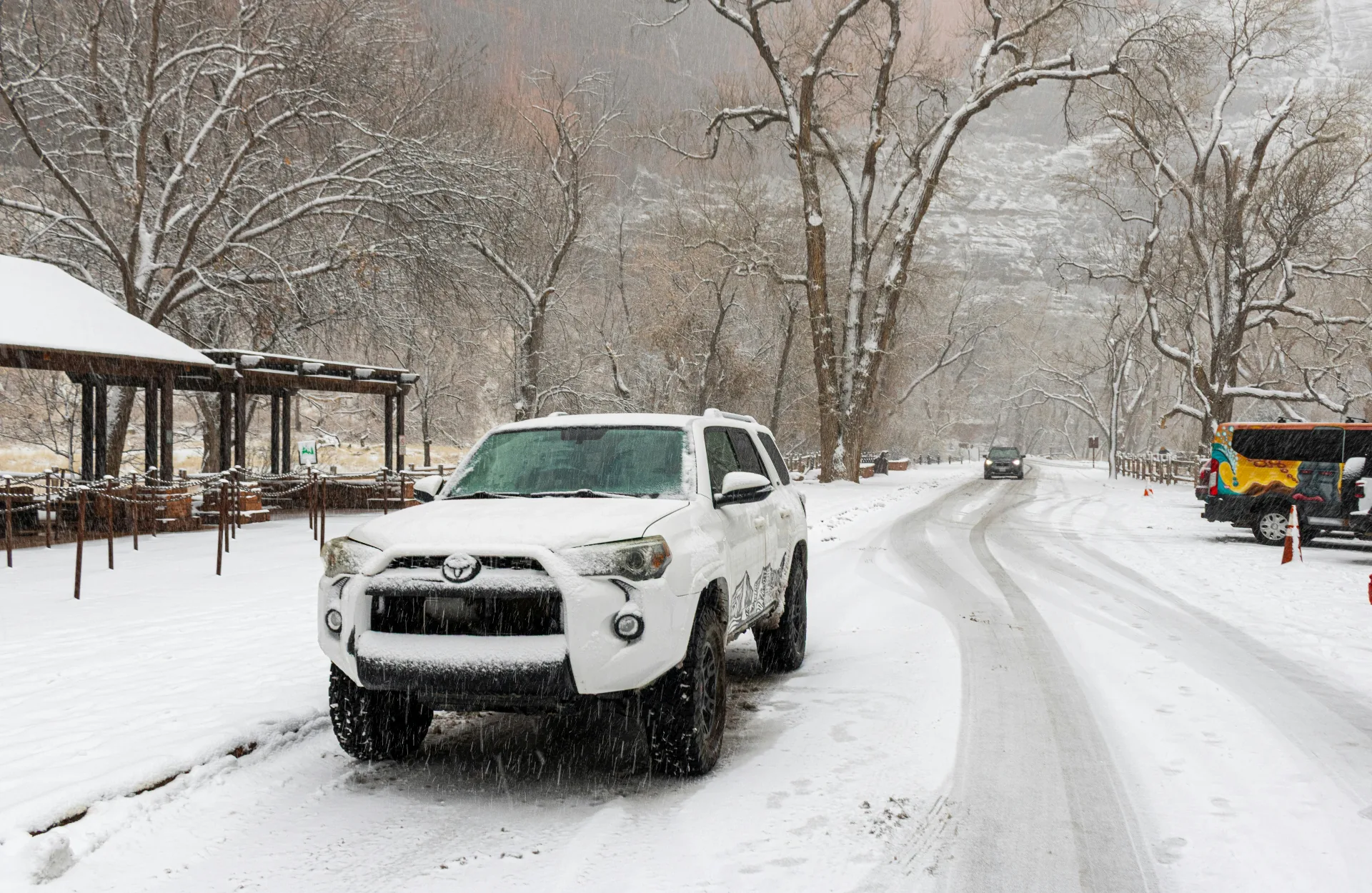 Snow-covered Toyota 4Runner on a snowy Southern Utah canyon road — illustrating why Washington County drivers keep comprehensive coverage year-round