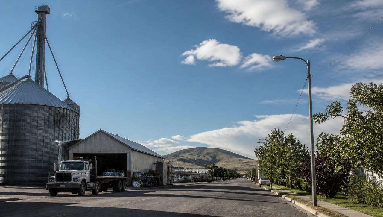 Farm-town main street with grain and equipment buildings in Enterprise, Utah (ZIP 84725) — business insurance, BOP, general liability, commercial property and workers' comp for Enterprise, Utah employers