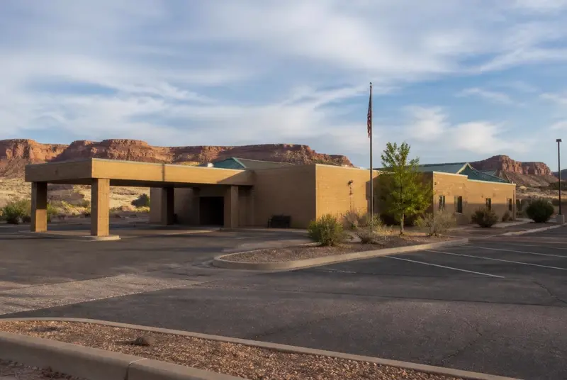 Small rural critical-access hospital with a covered emergency entrance under southern Utah mesas — Kane County Hospital handles local ER and primary care for 84741 households