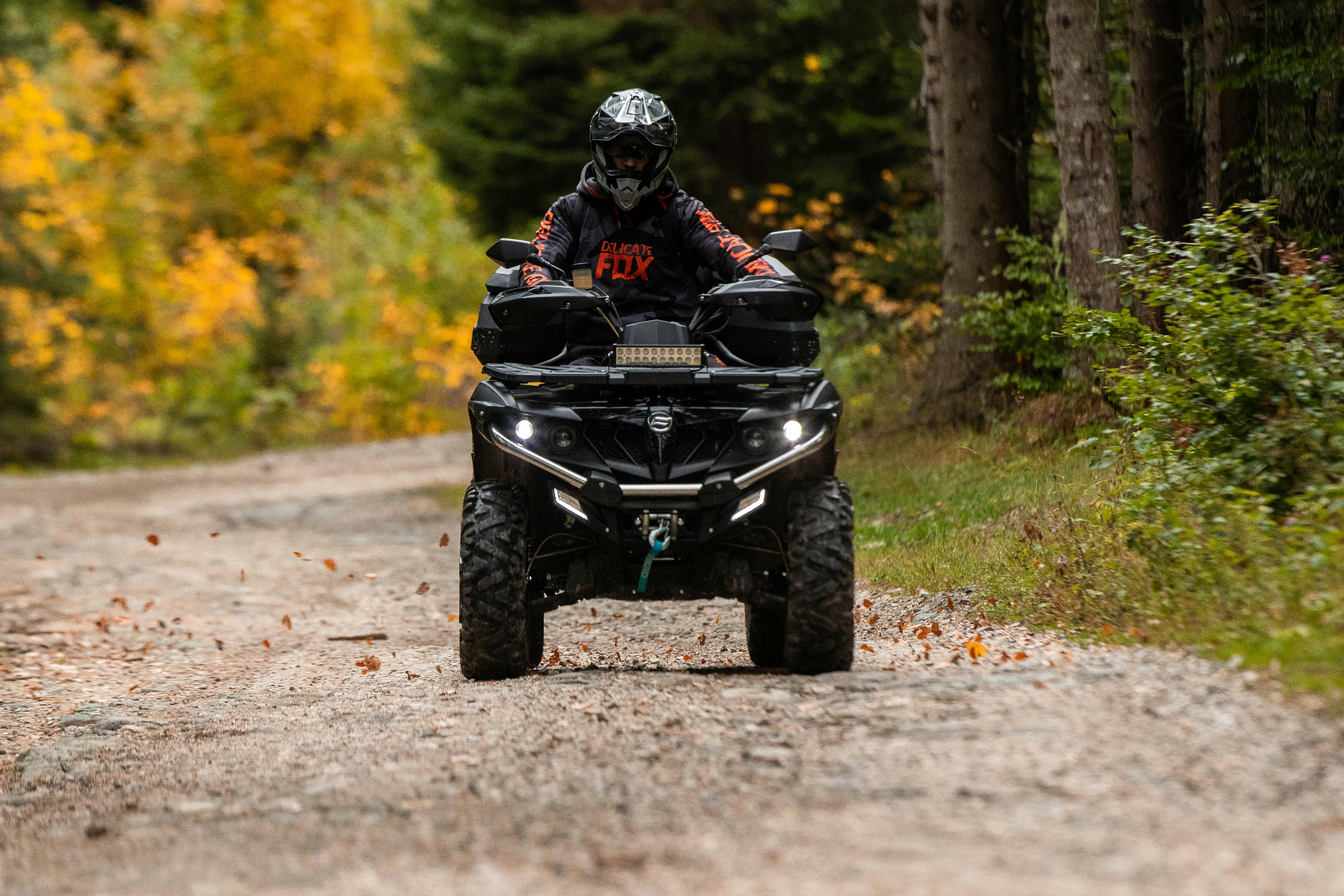 ATV rider on a forest trail with autumn foliage — Washington City ATV insurance for Pine Valley and Kolob Terrace rides