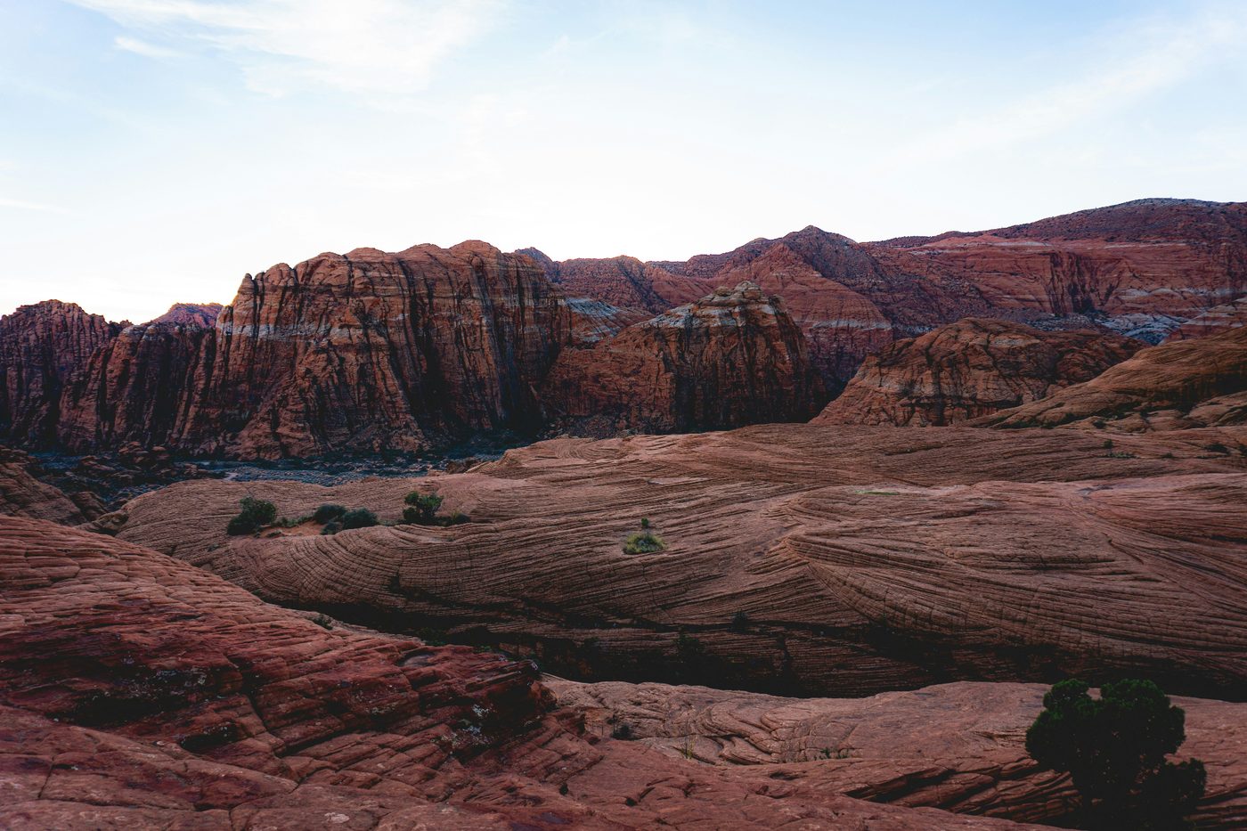Snow Canyon red sandstone cliffs and slickrock at dusk on the western edge of Santa Clara, Utah (84765) — wildland-urban interface that shapes home insurance rebuild costs