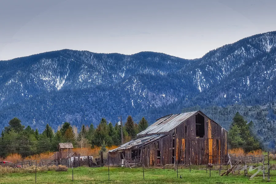 Old wooden barn beneath snow-dusted Pine Valley Mountain in winter — the winter ice and snowpack conditions that drive Pine Valley 84781 collision-coverage decisions