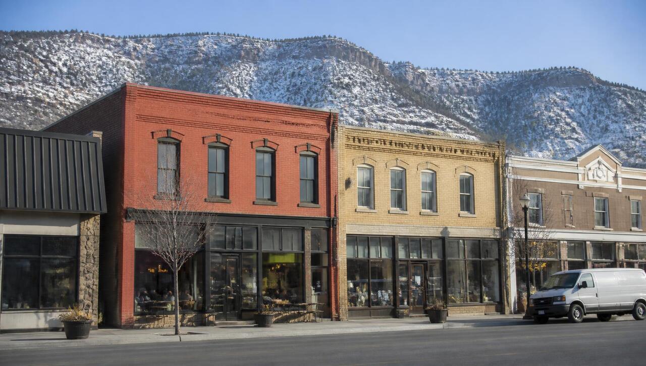 Historic Main Street storefronts under fresh snow in Cedar City, Utah (ZIP 84720, 84721) — business insurance, BOP, general liability, commercial property and workers' comp for Cedar City, Utah employers