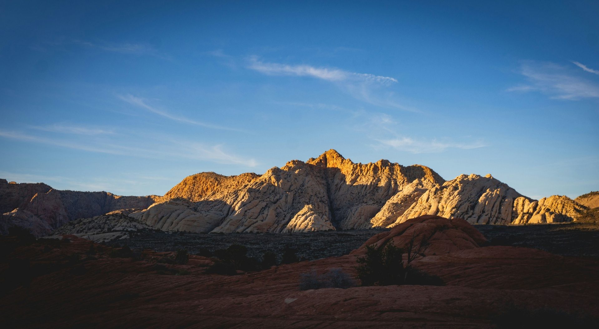 Homeowners insurance Ivins, Utah (84738) — red sandstone cliffs at sunset above Kayenta and central Ivins, where custom-home rebuild costs and the wildland-urban interface shape 84738 home policies
