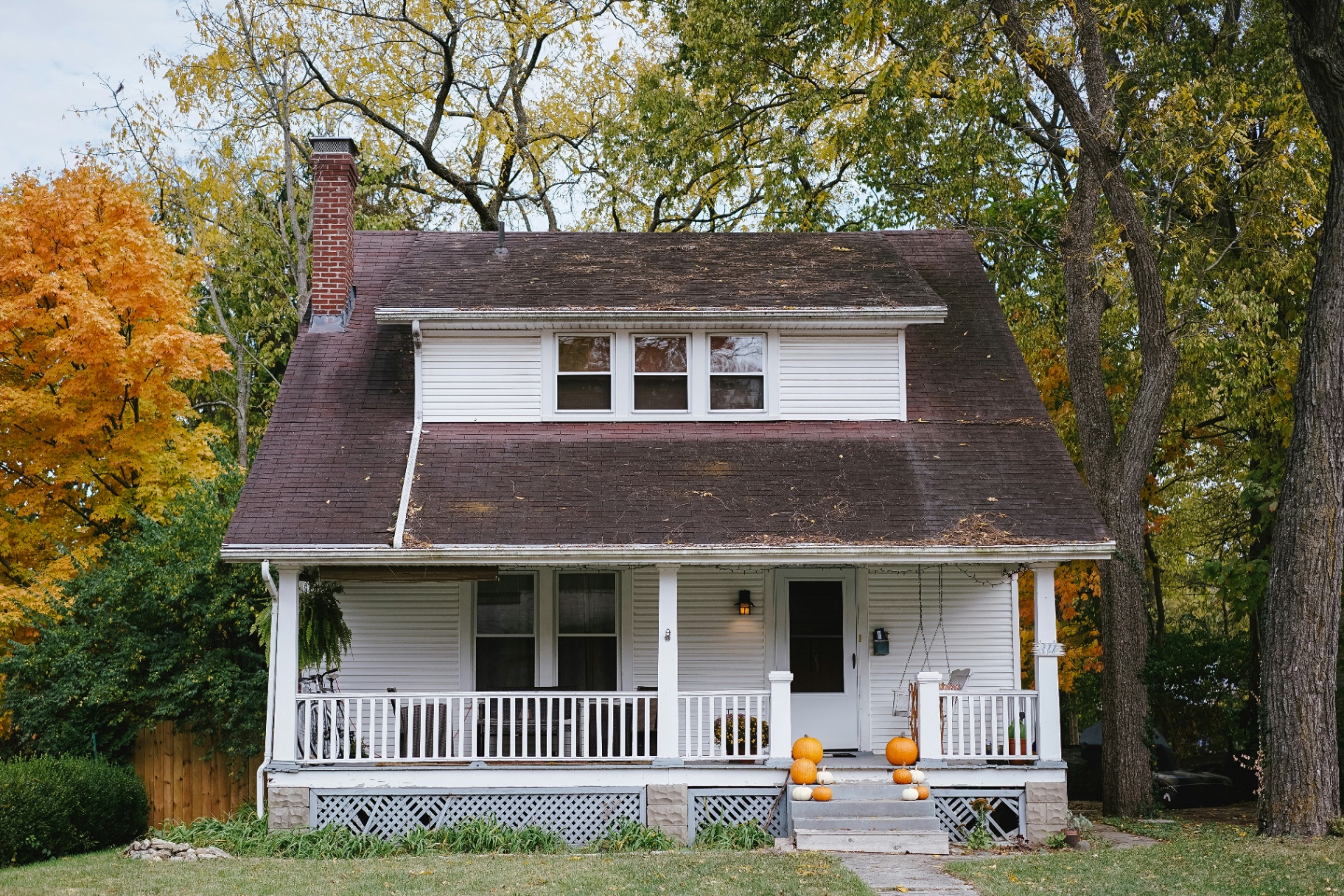 White cottage rental with covered porch and autumn trees — La Verkin, UT area rental home