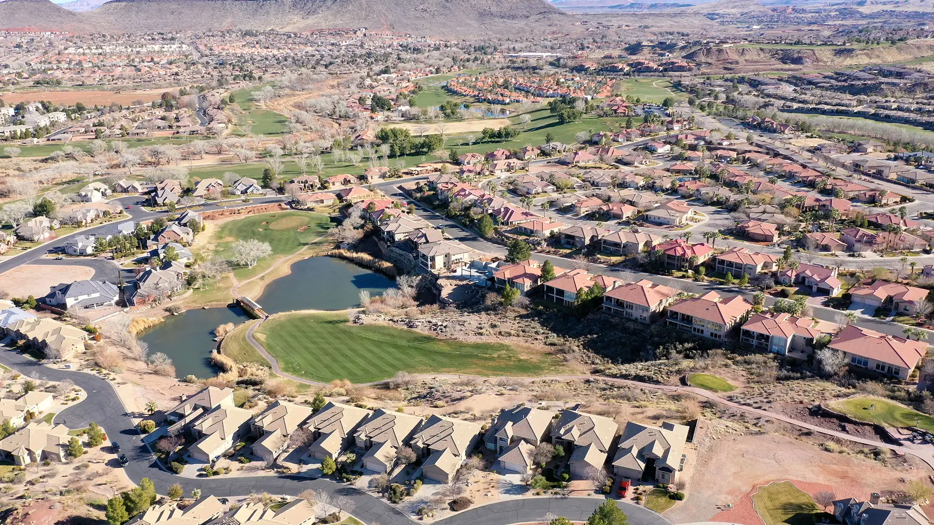 Aerial view of Sunbrook neighborhood homes and golf course in St. George, Utah — typical Washington County HOA community OnPoint insures.