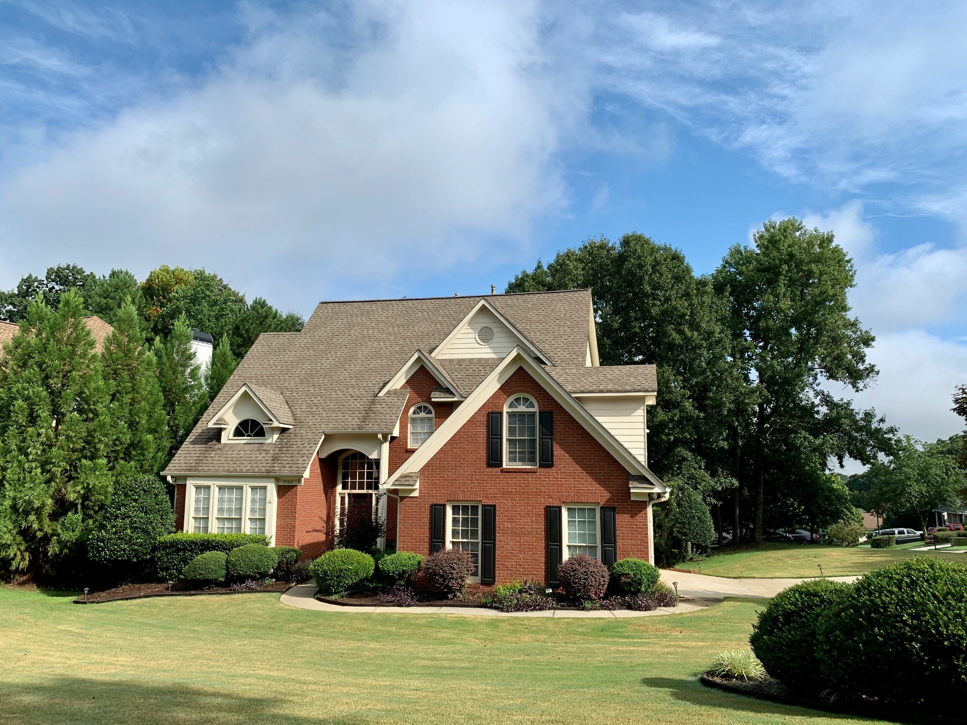 Red brick two-story rental home under blue Southern Utah sky — renters insurance in La Verkin, UT