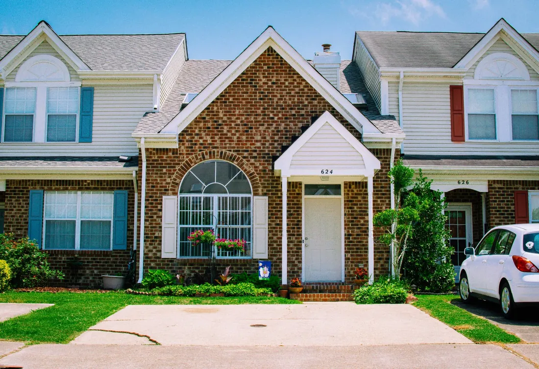 Brick townhome rental unit with a covered entry