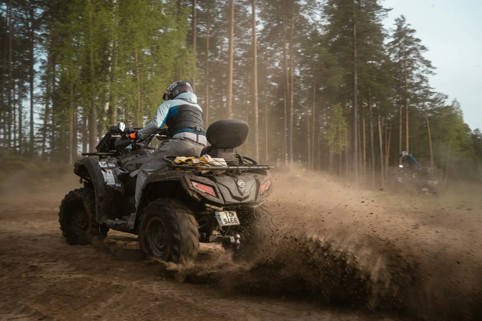 ATV roosting dirt on a forest trail — comprehensive coverage for mud, rocks, and trail damage