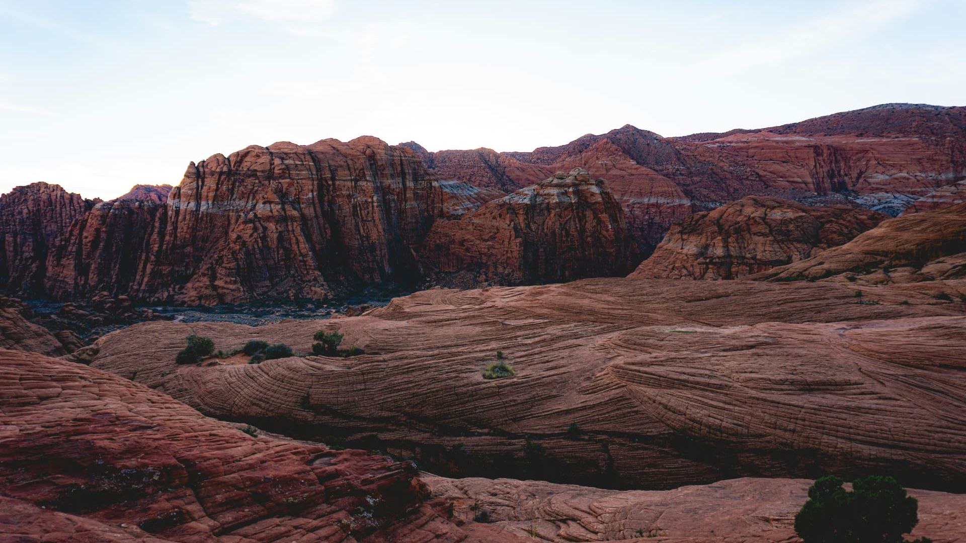 Red rock cliffs and slickrock benches at dusk in Snow Canyon near Ivins, Utah — ACA and off-Marketplace health insurance enrollment for 84738 households, Kayenta and Entrada early retirees, and self-employed families