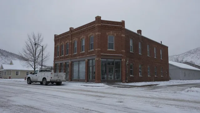 Historic brick main-street building and a service truck in wintry Parowan, Utah — local commercial insurance risk factors for Parowan, Utah 84761 businesses