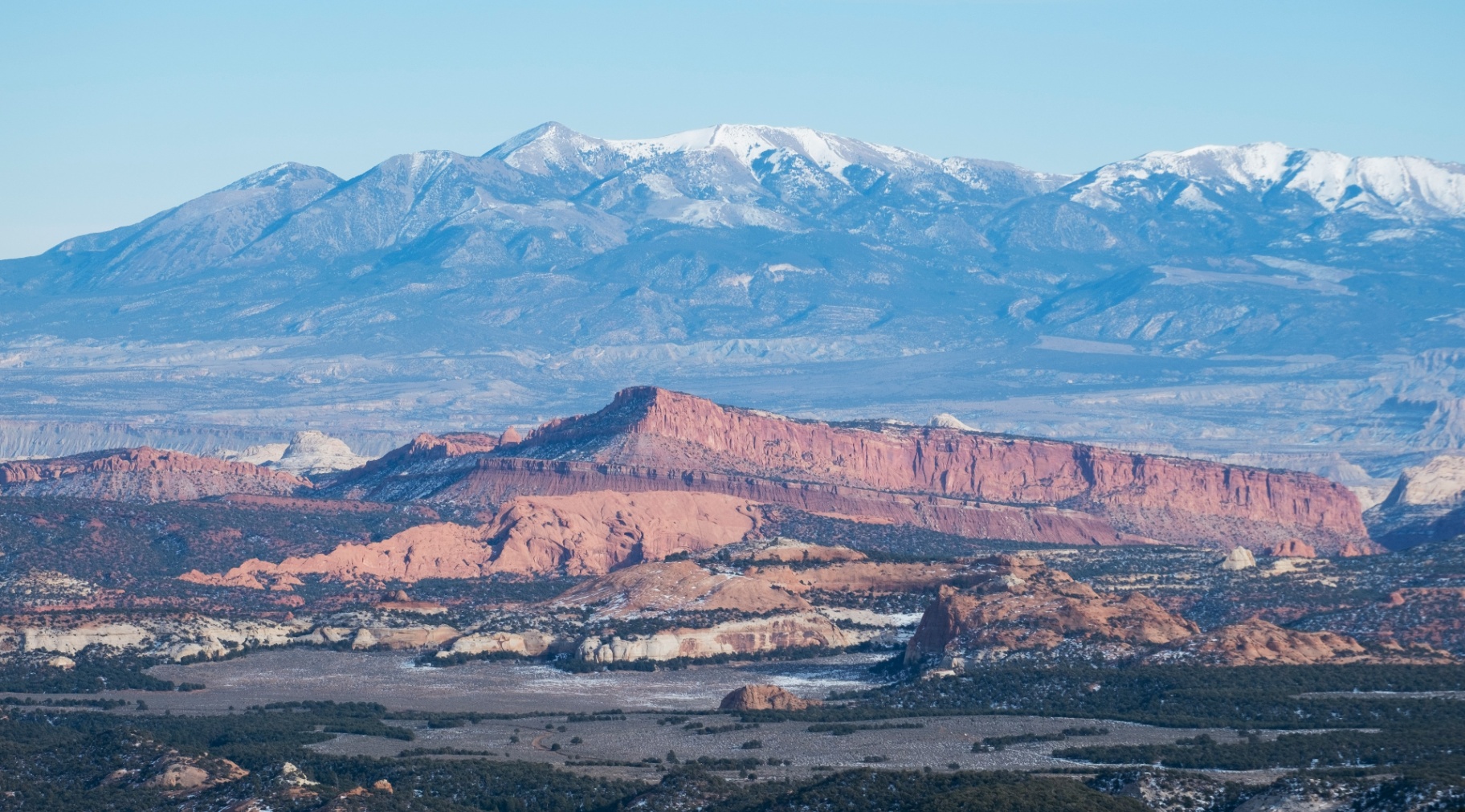 Snow-capped Pine Valley Mountains rising above red sandstone near Ivins, Utah