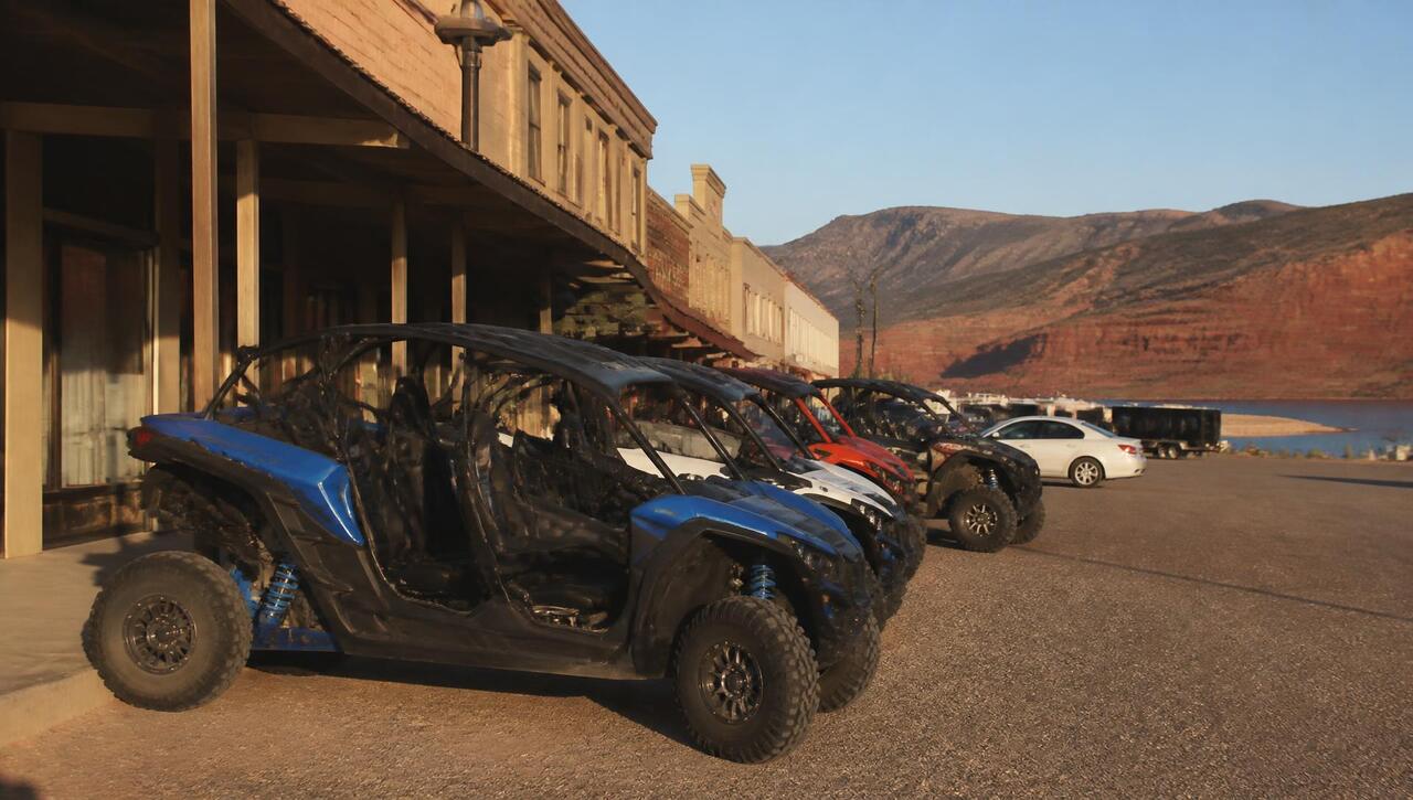 UTV rental shop with side-by-sides lined up on the lot in Hurricane, Utah beneath red cliffs (ZIP 84737) — business insurance, BOP, general liability, commercial property and workers' comp for Hurricane, Utah employers