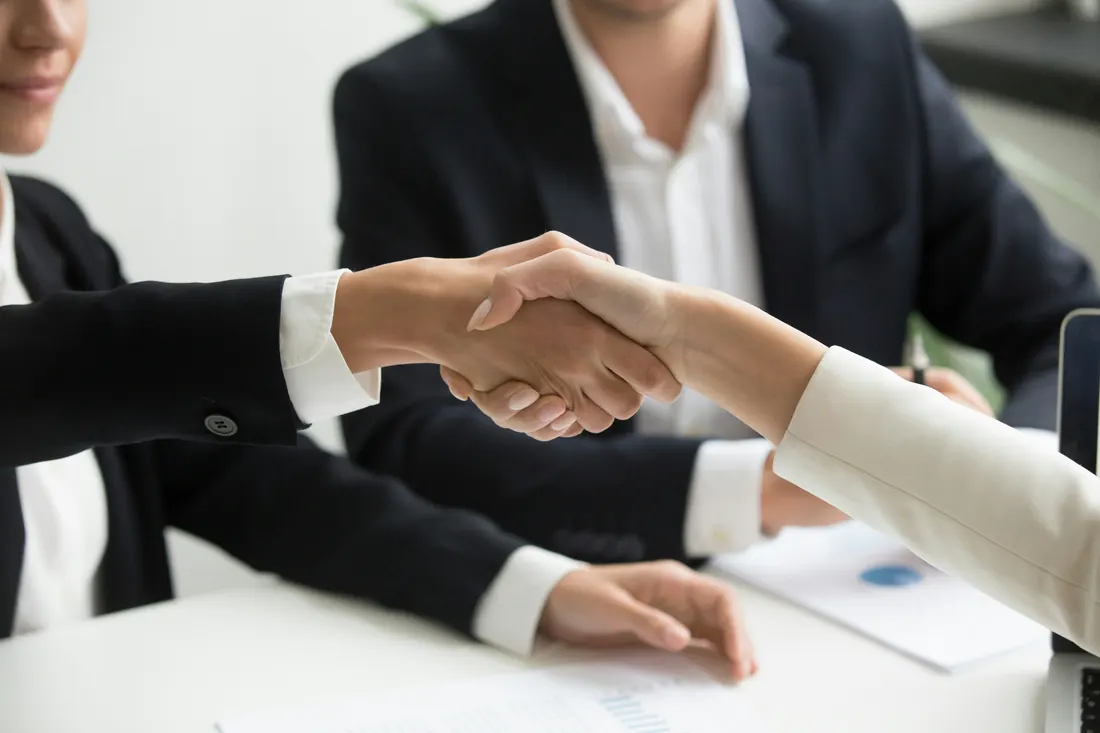 Close-up business handshake — workers' compensation and employer obligations in Utah