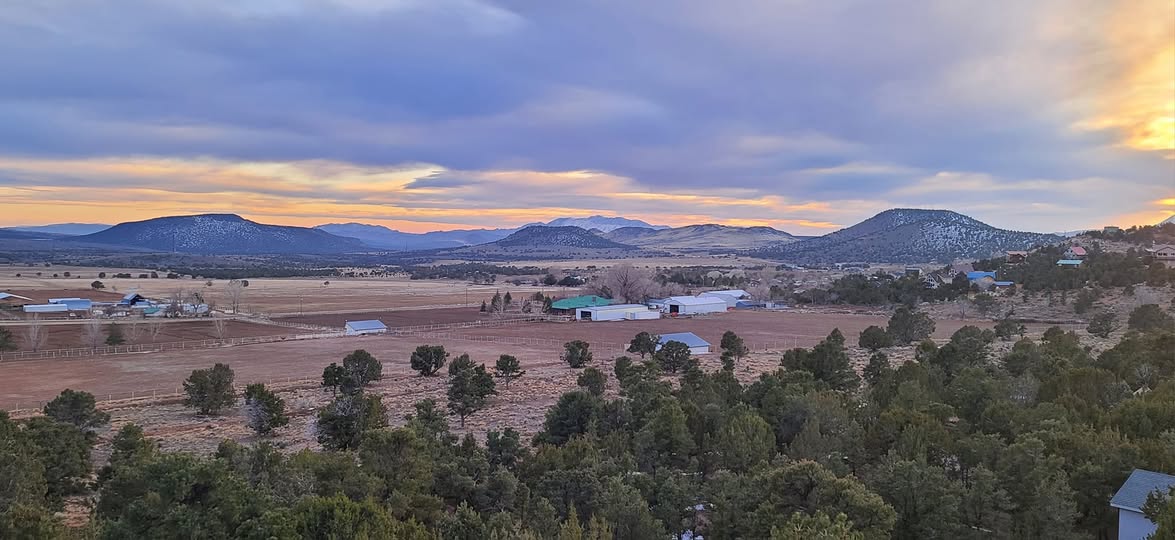 Central, Utah ranchland and valley at sunset with the Pine Valley Mountains on the horizon — auto insurance for Central and Highway 18 corridor drivers