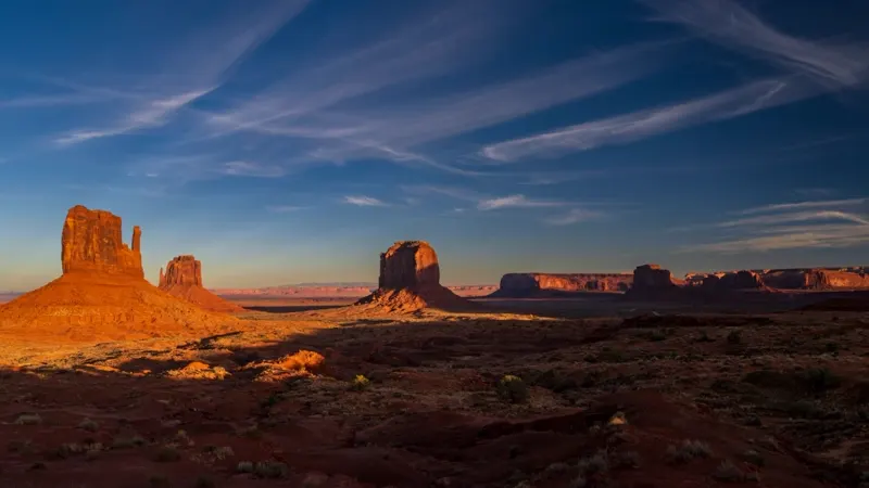 Red rock buttes and open desert at sunset in Southern Utah — wide-open country served by St. George health insurance plans