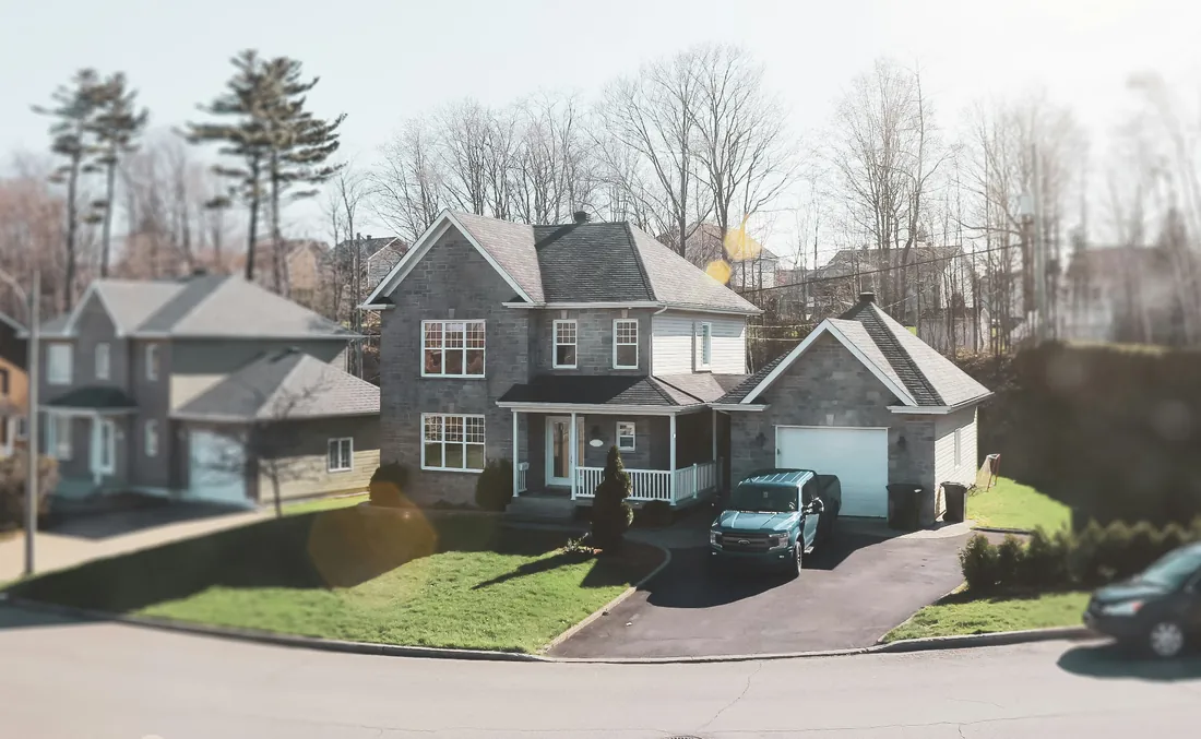 Suburban street with rental homes and a truck in the driveway
