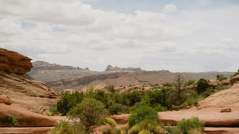 Red sandstone benches and juniper flats east of Washington City, Utah — the 84780 growth corridor where OnPoint enrolls families in ACA Marketplace plans