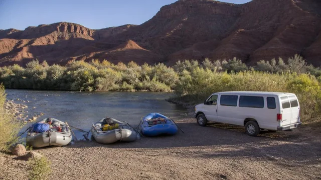 River outfitter's rafts and shuttle staged beside the Virgin River in Virgin, Utah — local commercial insurance risk factors for Virgin, Utah 84779 businesses