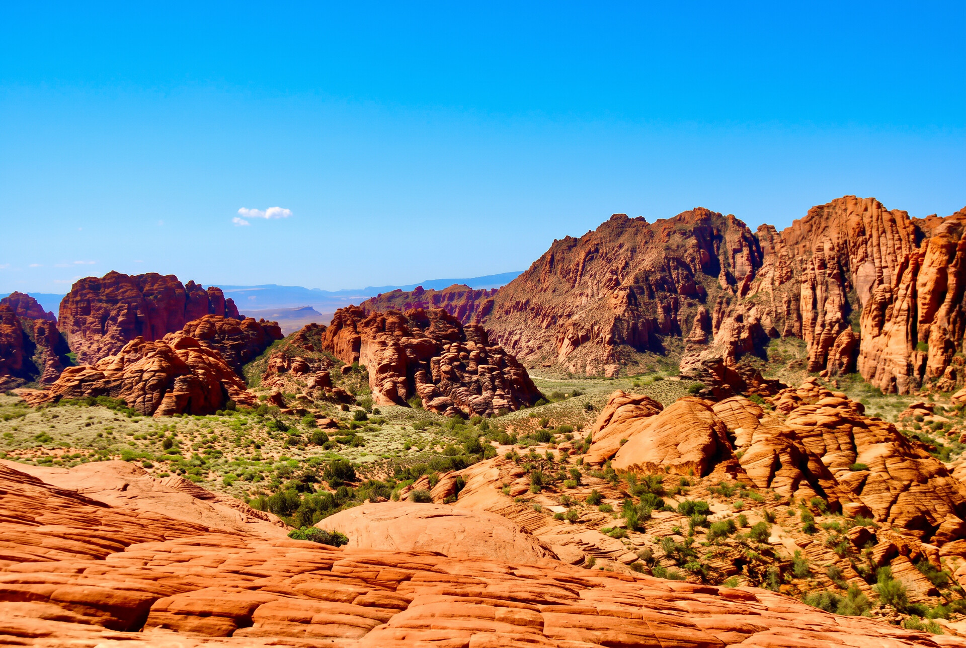 Red rock sandstone formations of Snow Canyon State Park under a clear blue sky near St. George, Utah
