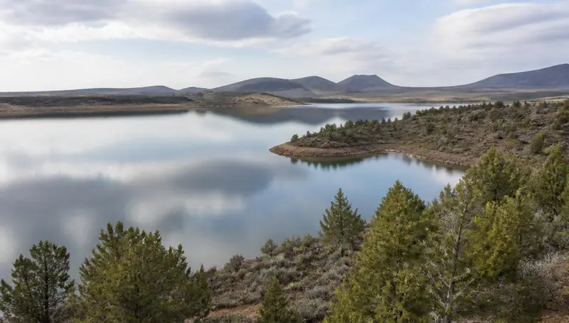 Enterprise Reservoir holding still water below sagebrush hills in western Washington County — health insurance and ACA Marketplace enrollment for Enterprise, Utah 84725 households