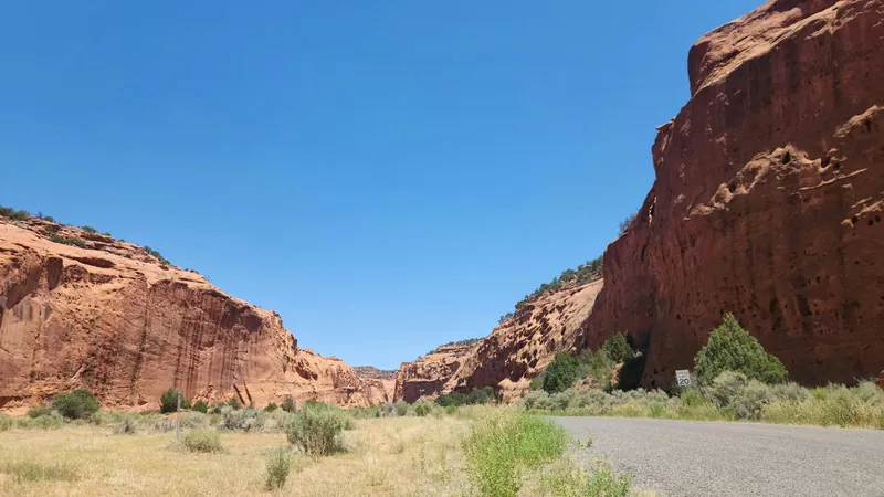 Highway curving through red rock canyon walls on the Zion corridor east of Hurricane, Utah — the SR-9 tourism economy that drives seasonal 1099 income on 84737 ACA applications