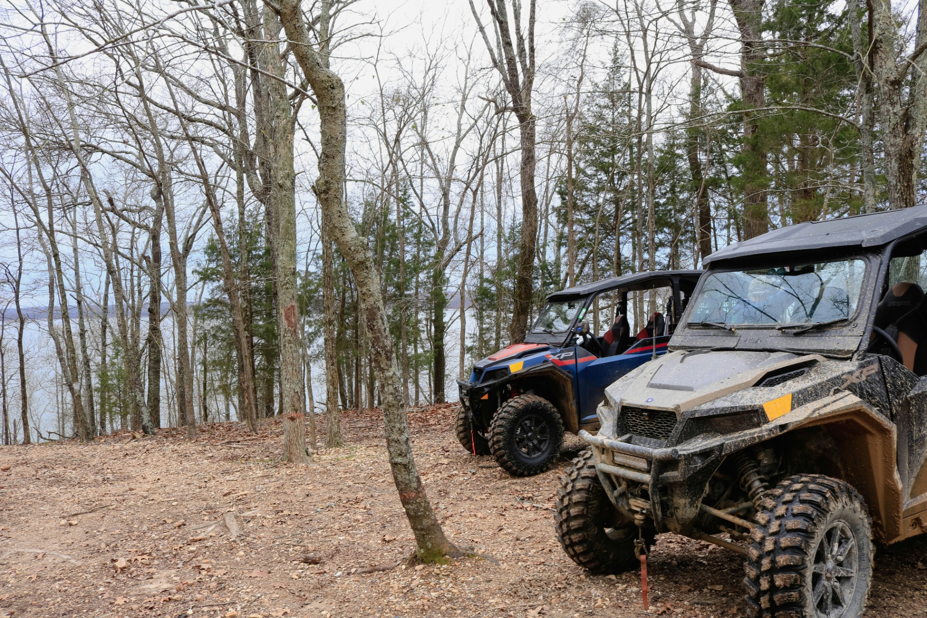 Two side-by-side UTVs parked on a trail overlooking a lake — ATV and UTV insurance across Utah