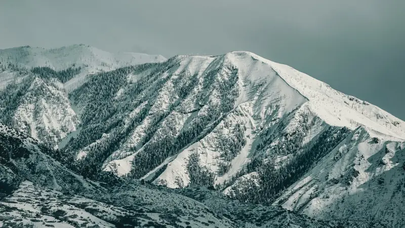 Snow-covered mountain ridgeline above Cedar City, Utah — 84720 ACA health insurance for Iron County contractors, seasonal workers, and self-employed families