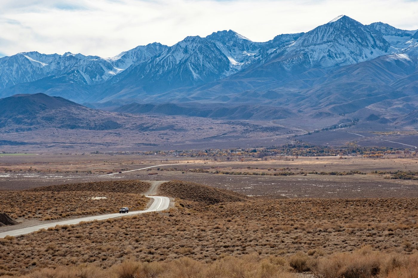 Snow-capped Virgin Mountains looming over the Mesquite, Nevada valley and I-15 corridor — the wildland-urban interface and rebuild-cost profile carriers rate into every 89027 homeowners insurance quote