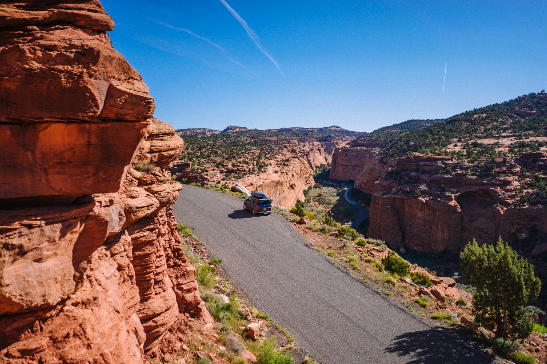 Vehicle driving a red-rock canyon highway in Southern Utah — the kind of route Washington County drivers cover daily.